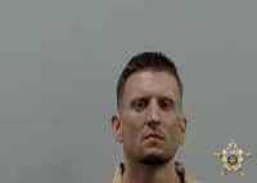 Mugshot of JUSTIN E HUGHES
